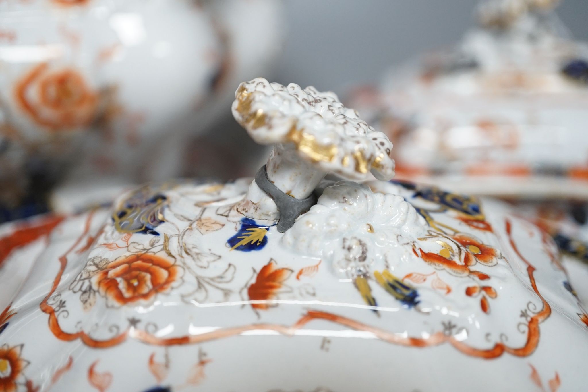An early 19th century stone china soup tureen and cover on stand, decorated in cobalt blue and iron red, a similar tureen, a pair of small covered dishes, Staffordshire spaniels, etc.